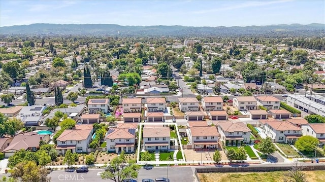 aerial view of residential area featuring mountains