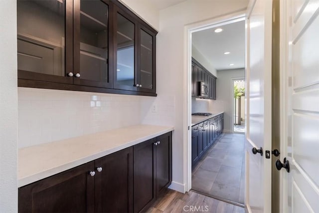 bar featuring backsplash, stainless steel appliances, recessed lighting, light wood finished floors, and baseboards