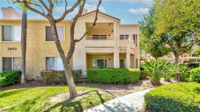 2400 Del Mar Way, Corona, CA 92882 - view of front of home featuring a balcony, stucco siding, a chimney, and a tiled roof