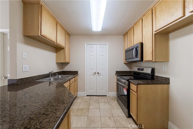 2400 Del Mar Way, Corona, CA 92882 - kitchen with appliances with stainless steel finishes, a sink, dark stone counters, baseboards, and light tile patterned floors