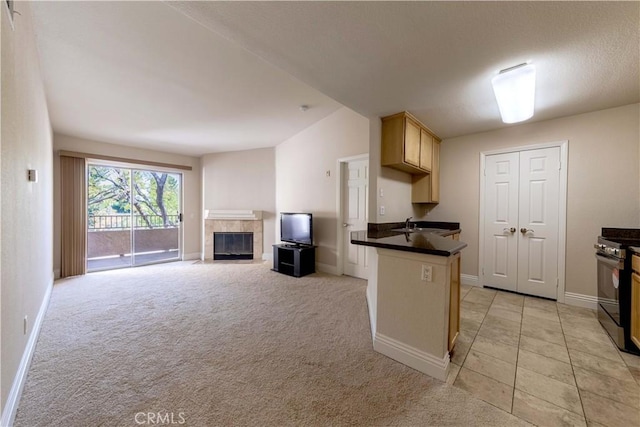 2400 Del Mar Way, Corona, CA 92882 - kitchen featuring stainless steel range with gas stovetop, dark countertops, a fireplace, and baseboards