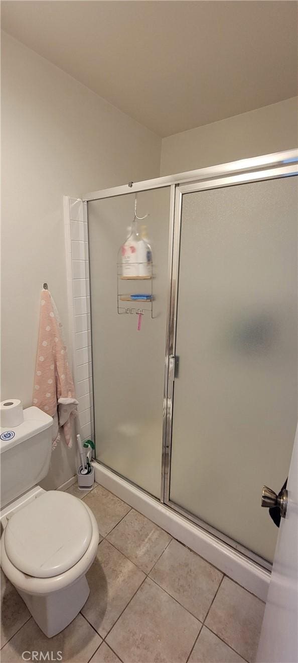 5400 Lindley Ave Unit 116, Encino, CA 91316 - bathroom featuring tile patterned floors, a shower stall, and toilet