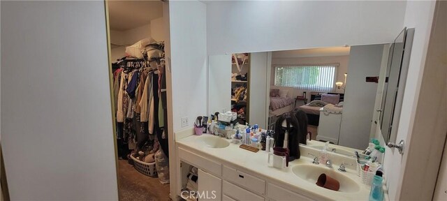 5400 Lindley Ave Unit 116, Encino, CA 91316 - bathroom featuring double vanity, a spacious closet, and ensuite bathroom