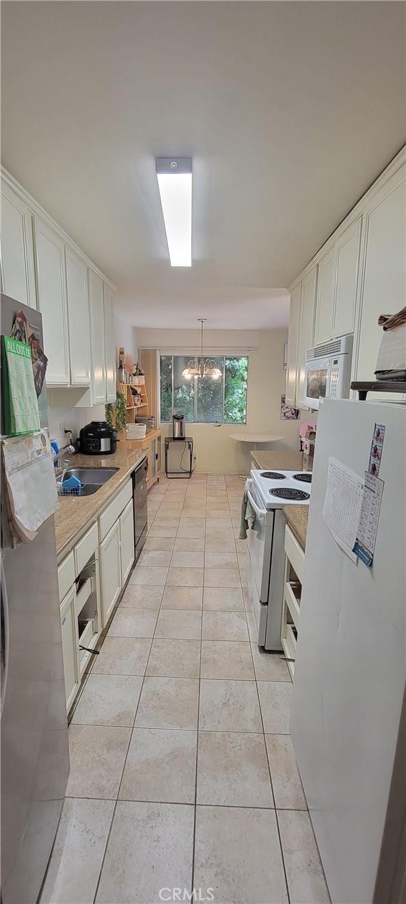 5400 Lindley Ave Unit 116, Encino, CA 91316 - kitchen featuring white appliances, white cabinetry, and light countertops