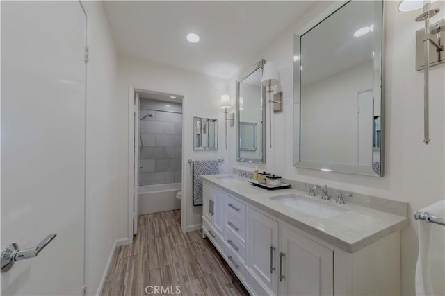13624 La Jolla Cir Unit D, La Mirada, CA 90638 - full bathroom featuring double vanity, shower / bath combination, recessed lighting, baseboards, and wood finished floors
