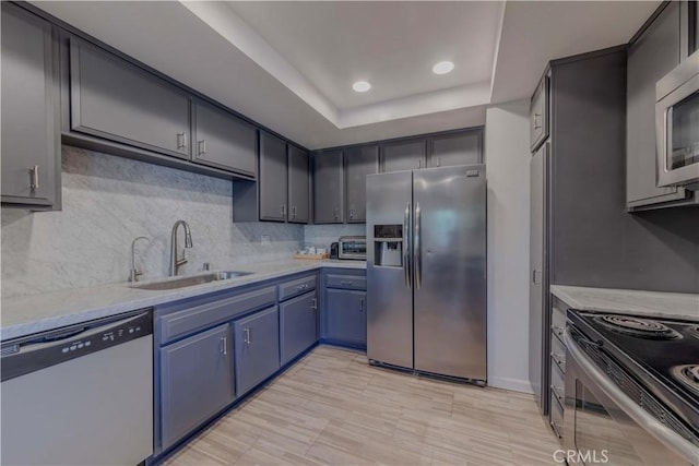 13624 La Jolla Cir Unit D, La Mirada, CA 90638 - kitchen with stainless steel appliances, a sink, blue cabinets, light countertops, and a tray ceiling