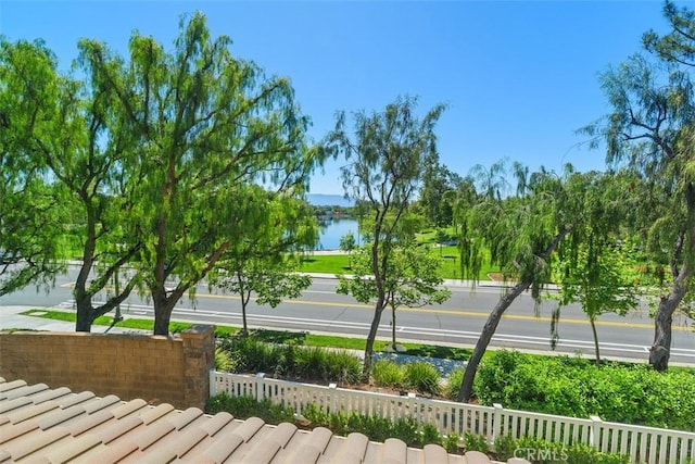 surrounding community featuring fence and a water view