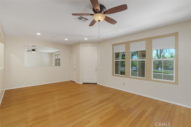 spare room featuring light wood-style floors, recessed lighting, baseboards, and ceiling fan