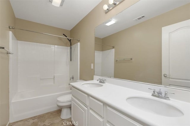 bathroom featuring toilet, double vanity, and shower / bathtub combination