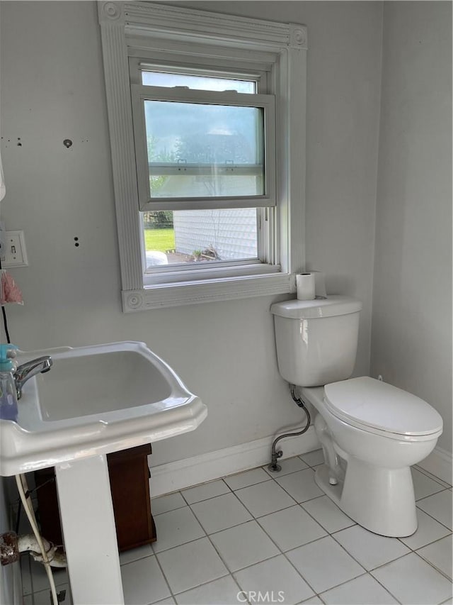 12409 Stamper Rd, Girard, IL 62640 - bathroom featuring tile patterned flooring, toilet, healthy amount of natural light, and baseboards