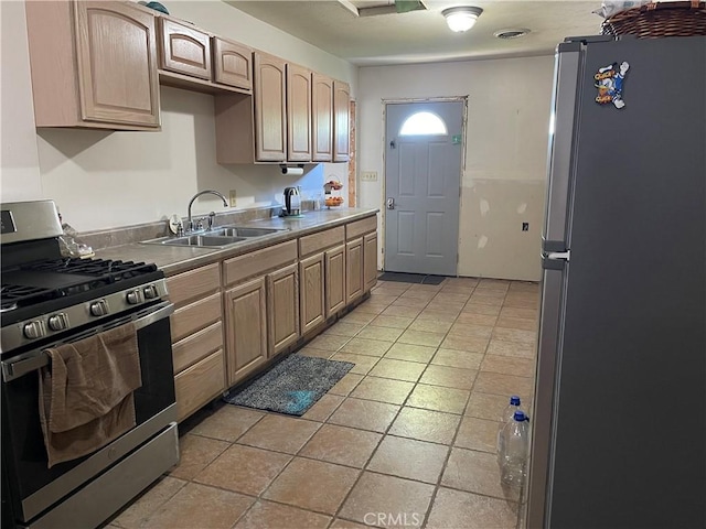 12409 Stamper Rd, Girard, IL 62640 - kitchen featuring appliances with stainless steel finishes, a sink, light brown cabinetry, and light tile patterned flooring