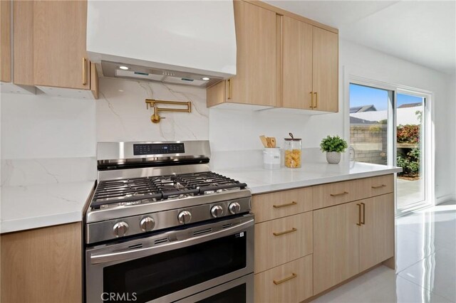 25082 Ericson Way, Laguna Hills, CA 92653 - kitchen featuring gas range, light brown cabinets, custom exhaust hood, and modern cabinets