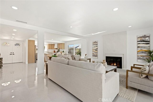 25082 Ericson Way, Laguna Hills, CA 92653 - living room with recessed lighting, a glass covered fireplace, and light tile patterned floors