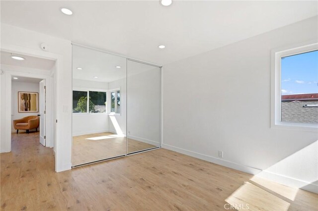 25082 Ericson Way, Laguna Hills, CA 92653 - unfurnished bedroom with light wood finished floors, recessed lighting, baseboards, and a closet