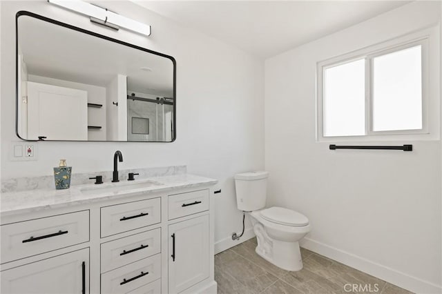 25082 Ericson Way, Laguna Hills, CA 92653 - full bathroom featuring baseboards, toilet, vanity, and an enclosed shower