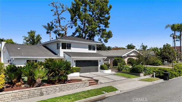 25082 Ericson Way, Laguna Hills, CA 92653 - traditional-style home featuring a tile roof, driveway, an attached garage, and stucco siding