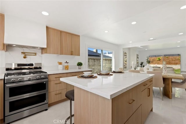 25082 Ericson Way, Laguna Hills, CA 92653 - kitchen with range with two ovens, modern cabinets, light brown cabinets, a kitchen island, and recessed lighting