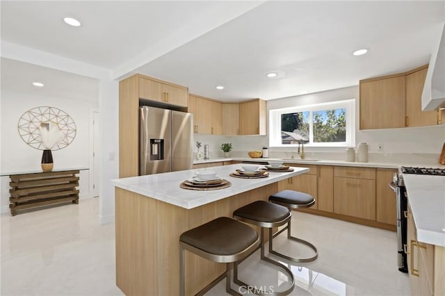 25082 Ericson Way, Laguna Hills, CA 92653 - kitchen with stainless steel appliances, light brown cabinets, a kitchen breakfast bar, a sink, and recessed lighting