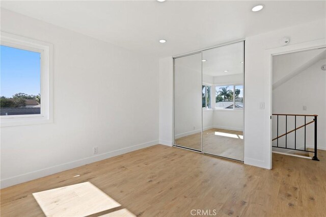 25082 Ericson Way, Laguna Hills, CA 92653 - unfurnished bedroom featuring a closet, baseboards, wood finished floors, and recessed lighting