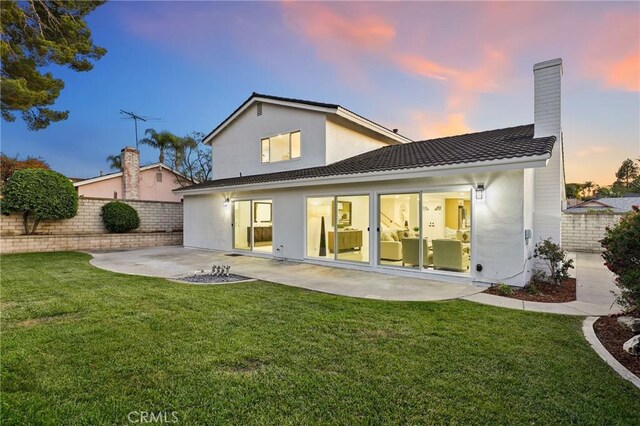 25082 Ericson Way, Laguna Hills, CA 92653 - back of house featuring a patio area, stucco siding, a chimney, and a tiled roof