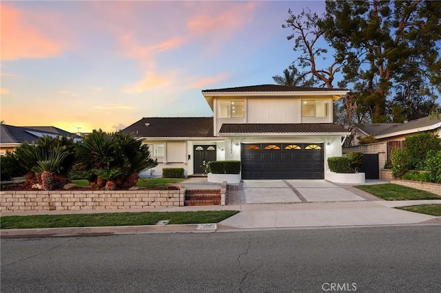 25082 Ericson Way, Laguna Hills, CA 92653 - view of front of home with concrete driveway, an attached garage, fence, and a tiled roof