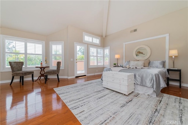 bedroom with wood finished floors, access to outside, beam ceiling, baseboards, and high vaulted ceiling