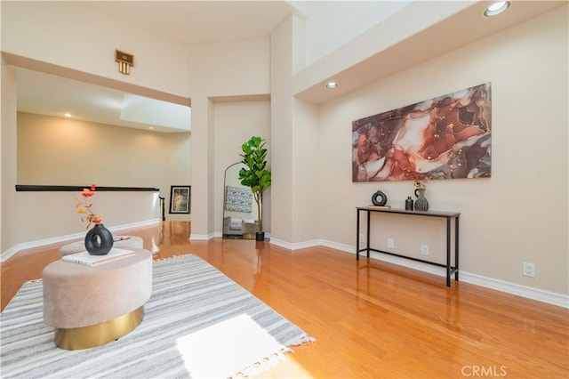 living area featuring wood finished floors, recessed lighting, and baseboards