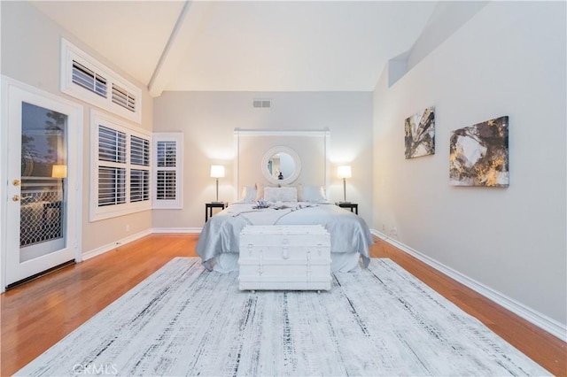 bedroom featuring wood finished floors, baseboards, and access to outside