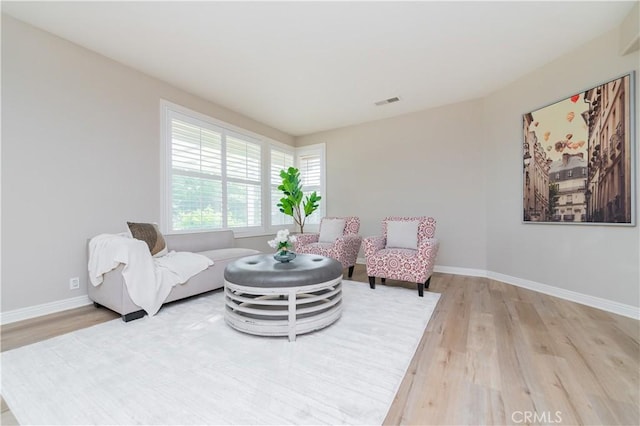 living area with light wood finished floors and baseboards