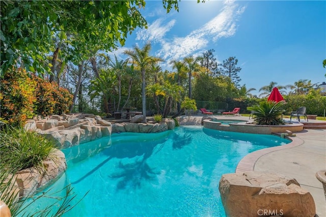 swimming pool featuring an in-ground hot tub, a fenced backyard, and a patio