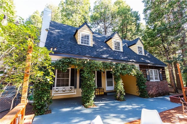 222 Holiday Dr, Lake Arrowhead, CA 92352 - cape cod home with a chimney, a shingled roof, and a patio area