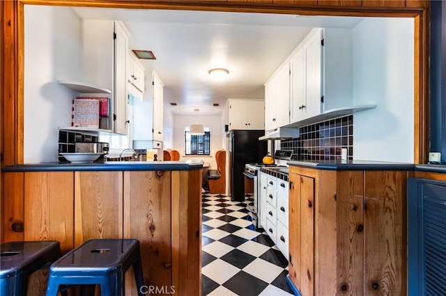 222 Holiday Dr, Lake Arrowhead, CA 92352 - kitchen with light flooring, range with gas stovetop, white cabinets, open shelves, and tasteful backsplash