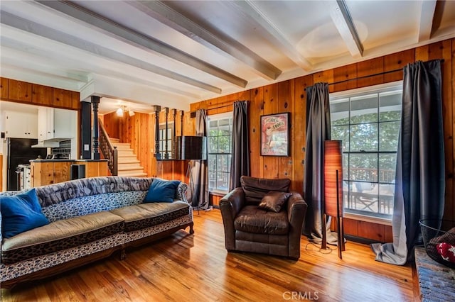 222 Holiday Dr, Lake Arrowhead, CA 92352 - living room with beam ceiling, plenty of natural light, stairs, wood walls, and light wood-type flooring