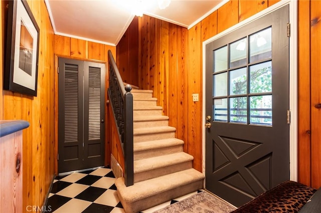 222 Holiday Dr, Lake Arrowhead, CA 92352 - foyer entrance featuring tile patterned floors, wooden walls, stairs, and ornamental molding