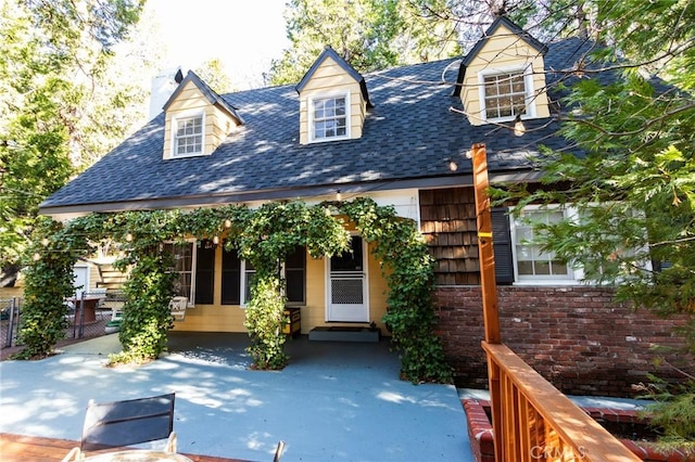 222 Holiday Dr, Lake Arrowhead, CA 92352 - view of front of property featuring a shingled roof, a chimney, fence, and brick siding
