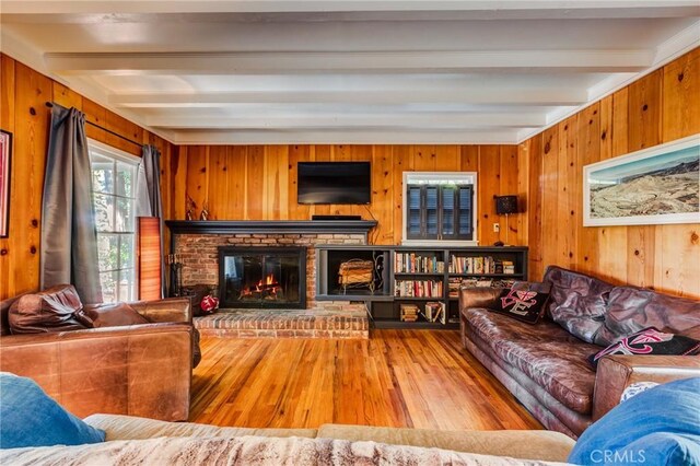222 Holiday Dr, Lake Arrowhead, CA 92352 - living area featuring beamed ceiling, wood finished floors, a brick fireplace, and wooden walls