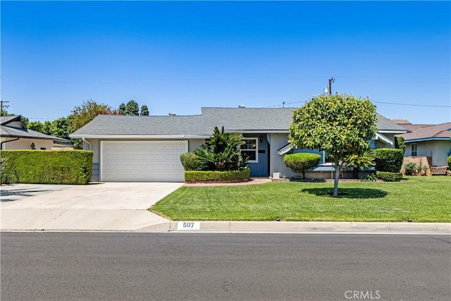 507 S Gaybar Ave, West Covina, CA 91790 - view of front of home featuring an attached garage, driveway, and a front lawn