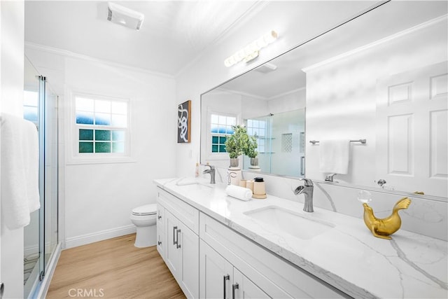 507 S Gaybar Ave, West Covina, CA 91790 - bathroom with ornamental molding, a shower stall, double vanity, wood finished floors, and toilet