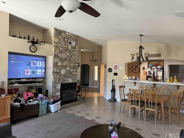 1255 Duckweed Trl, Campo, CA 91906 - tiled living area with a ceiling fan, a stone fireplace, a chandelier, and arched walkways