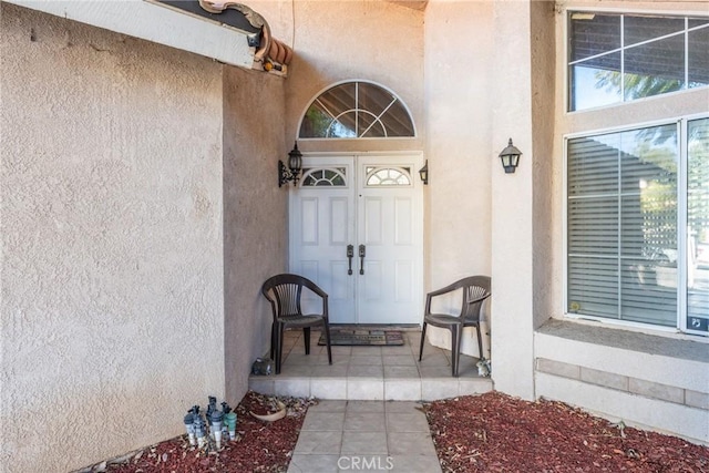 9656 Pebble Brook Dr, Moreno Valley, CA 92557 - view of exterior entry featuring stucco siding and a porch