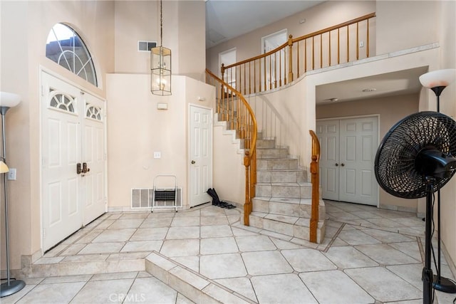 9656 Pebble Brook Dr, Moreno Valley, CA 92557 - foyer entrance featuring a high ceiling, stairway, and light tile patterned flooring