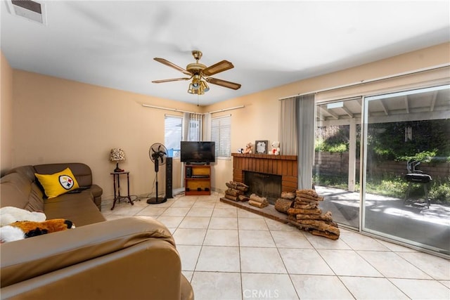 9656 Pebble Brook Dr, Moreno Valley, CA 92557 - living room featuring ceiling fan, light tile patterned floors, and a fireplace