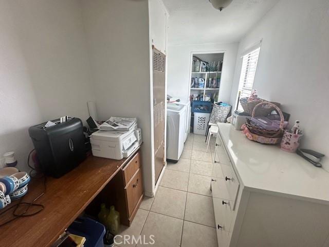 kitchen with washer and dryer, light tile patterned flooring, an office area, and brown cabinets