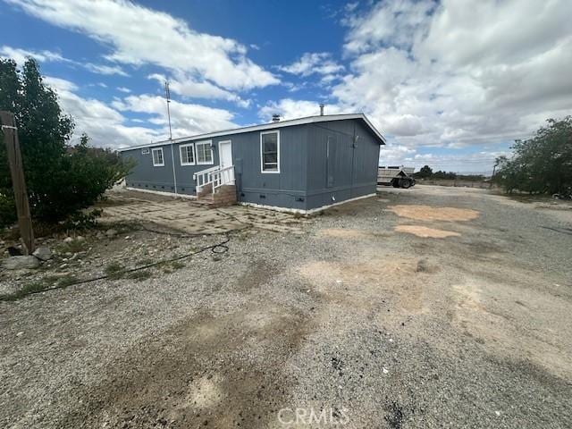 view of front of house with crawl space and entry steps