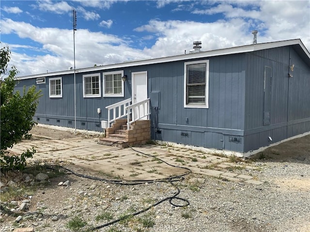 manufactured / mobile home featuring crawl space, entry steps, and a patio area