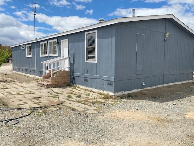 view of front of home with crawl space, entry steps, and a patio area