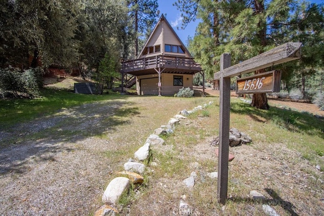 15616 San Moritz Dr, Pine Mountain Club, CA 93222 - view of front of home with dirt driveway, a deck, and a garage