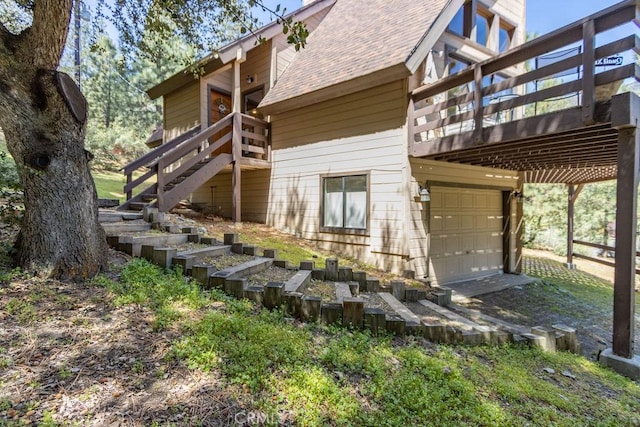 15616 San Moritz Dr, Pine Mountain Club, CA 93222 - rear view of property with stairs, a garage, a shingled roof, and a deck