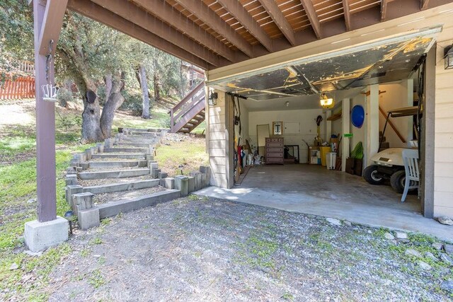 15616 San Moritz Dr, Pine Mountain Club, CA 93222 - view of patio featuring stairway and a garage