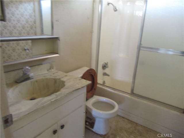 bathroom with enclosed tub / shower combo, toilet, and vanity